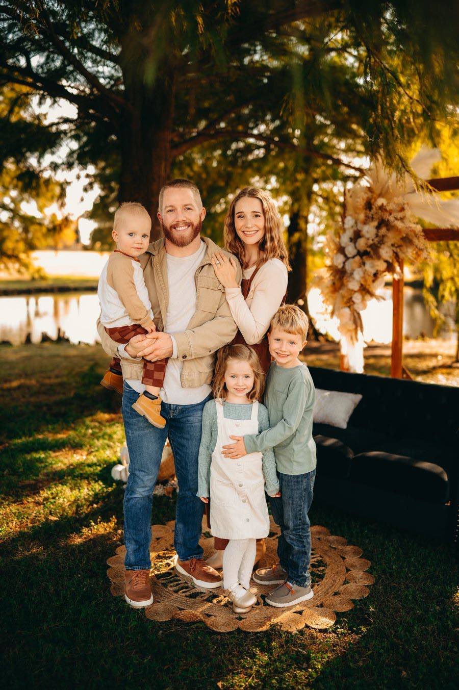 My family at golden hour beside a pond in the fall